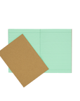Socolo exercise book with a kraft cover, open showing its green paper pages, lined with green ink.