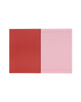 Socolo notebook, open showing its pink paper pages, lined with pink ink, and a red inner cover.